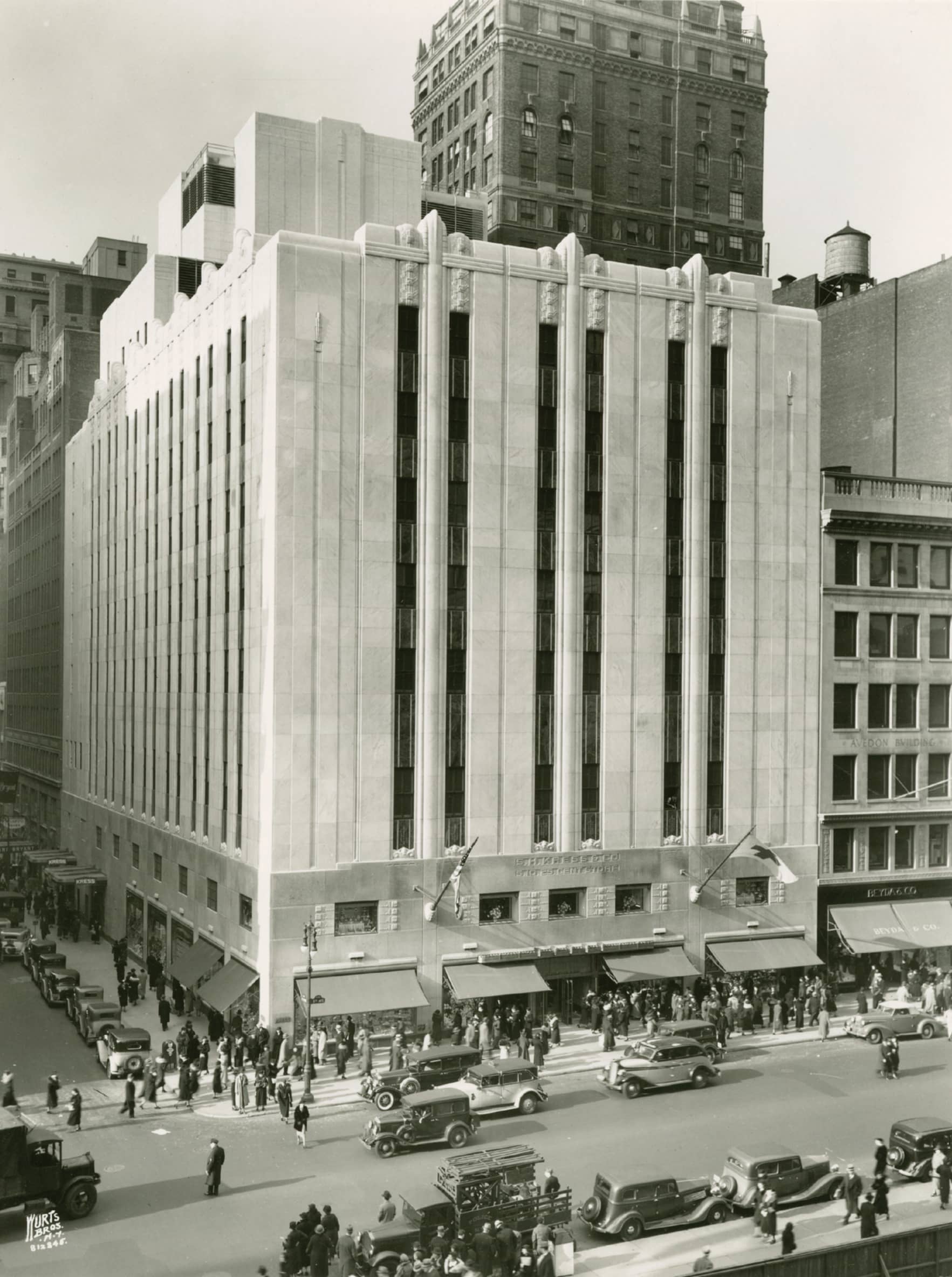 A black and white photograph of facade of the S.H. Kress & Company flagship store on Fifth Avenue in New York City. 